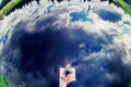 Deceptive reflection of blue sky with clouds on ponds water. Mans foot steps above water as if he is about to dive in. Abstract