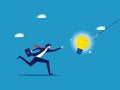 Deceptive thoughts. Businessman chasing light bulb