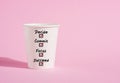 Decide, commit, focus and succeed on a paper coffee cup on pink background