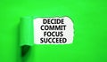 Decide commit focus succeed symbol. Concept word Decide Commit Focus Succeed on beautiful white paper. Beautiful green paper Royalty Free Stock Photo