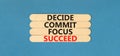 Decide commit focus succeed symbol. Concept word Decide Commit Focus Succeed on beautiful wooden stick. Beautiful blue table blue Royalty Free Stock Photo