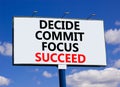 Decide commit focus succeed symbol. Concept word Decide Commit Focus Succeed on beautiful big billboard. Beautiful blue sky cloud Royalty Free Stock Photo