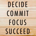 Decide, commit, focus, succeed with wooden background Royalty Free Stock Photo