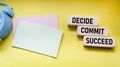 Decide Commit Succeed concept word on wooden blocks. Stickers for writing. The business solution is committed to success Royalty Free Stock Photo