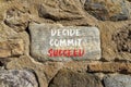 Decide commit succeed symbol. Concept word Decide Commit Succeed on beautiful big stone. Stone wall. Beautiful stone wall