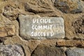 Decide commit succeed symbol. Concept word Decide Commit Succeed on beautiful big stone. Stone wall. Beautiful stone wall