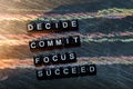 Decide Commmit Focus Succeed on wooden blocks. Cross processed image with blackboard background. Royalty Free Stock Photo