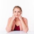 Decided blond woman sitting in sparse office smiling Royalty Free Stock Photo