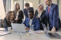 Deciding. Diverse group of co-workers having casual discussion in office. Executives during friendly discussion, month reporting, Royalty Free Stock Photo