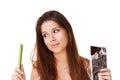 Decision, celery and chocolate with woman, choice and girl isolated on a white studio background. Nutrition, person and