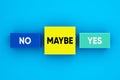 Decision making concept. Indecision and uncertainty. The words yes, no and maybe on colorful blocks