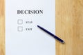 Decision paper with stay and exit choice on wood background Royalty Free Stock Photo