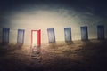 Decisive choice concept. Choose the right door for future success. Mysterious and surreal scene with multiple doorways in an open Royalty Free Stock Photo