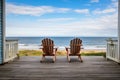 deck of a beach house with chairs looking out to the sea Royalty Free Stock Photo