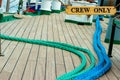 Deck of a boat with several ropes and a sign where it puts only the crew Royalty Free Stock Photo