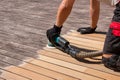 Deck builder sanding grey patina out of weathered ipe wood boards with deck sander Royalty Free Stock Photo