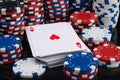 A deck of cards, surrounded by many stacks of chips to participate in gambling