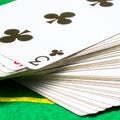 Deck of cards with triple clubs on top