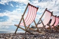 Deck chairs on the beach at the seaside summer vacation Royalty Free Stock Photo