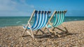 Deck chairs on a pebble beach