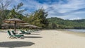 Deck chairs with soft mattresses stand in a row on the sandy beach Royalty Free Stock Photo