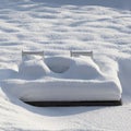Deckchairs with towering snow. Garden patio snowed under. Royalty Free Stock Photo