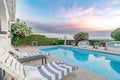 Deck chairs surrounding swimming pool Royalty Free Stock Photo