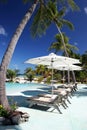 Deck chairs by the swimming pool in tropical resort in French Polynesia Royalty Free Stock Photo