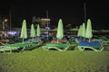 Deck chairs and umbrellas on the beach at night