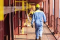 A deck crew of a merchant ship walking across the deck during his daily routine activities on board of the large container ship. Royalty Free Stock Photo