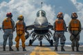 Deck crew signaling to a fighter jet on an aircraft carrier Royalty Free Stock Photo