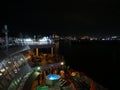 Deck of a cruise ship at night with the Puerto Rico pier lights in the distance Royalty Free Stock Photo