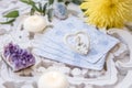 Deck with divination homemade Angel cards on bright white table, surrounded with semi precious stones crystals and candles.