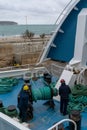 deck hands remove the bow lines and spring lines on the Gozo Channel ferry before departure Royalty Free Stock Photo