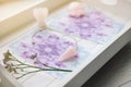 Deck with homemade Angel cards on white tray at home table witch selective focus on rose quartz.