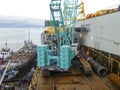 The deck lay barge. Pipes and Lifting cranes on the ship. Equipment for laying a pipeline on the seabed