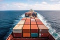 The deck of a massive container ship is shown, with rows of stacked containers towering overhead, as the vessel plows