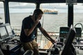 Deck navigation officer on the navigation bridge. He looks through binoculars