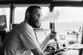 Deck navigation officer smokes a wad on the navigation bridge of yacht