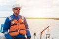 Deck Officer on deck of offshore vessel or ship , wearing PPE personal protective equipment