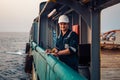 Deck Officer on deck of offshore vessel or ship , wearing PPE personal protective equipment. He fills checklist Royalty Free Stock Photo