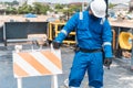 Deck officer with protective mask on the deck of a seagoing vessel, with PPE personal protective equipment