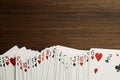 Deck of playing cards on wooden table, top view. Space for text Royalty Free Stock Photo