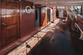 Deck of a retro sailboat with cabin entrances.