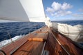 Details of a classic wood sailboat in open waters.