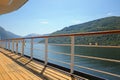 Deck of a ship as it cruises down the beautiful fjord with mountains & vilages along the water, Hardangerfjord, Norway Royalty Free Stock Photo