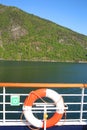 Deck of a ship & life ring as it cruises down the Sognefjord or Sognefjorden, Vestland county in Western Norway,. Royalty Free Stock Photo