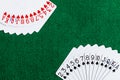 A Deck of standard playing cards with Hearts and spades fanned out in the corners of the frame on a green felt playing surface.