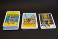 A deck of tarot cards laid out on a black background