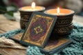 A deck of tarot cards is on a table with candles and a blanket Royalty Free Stock Photo